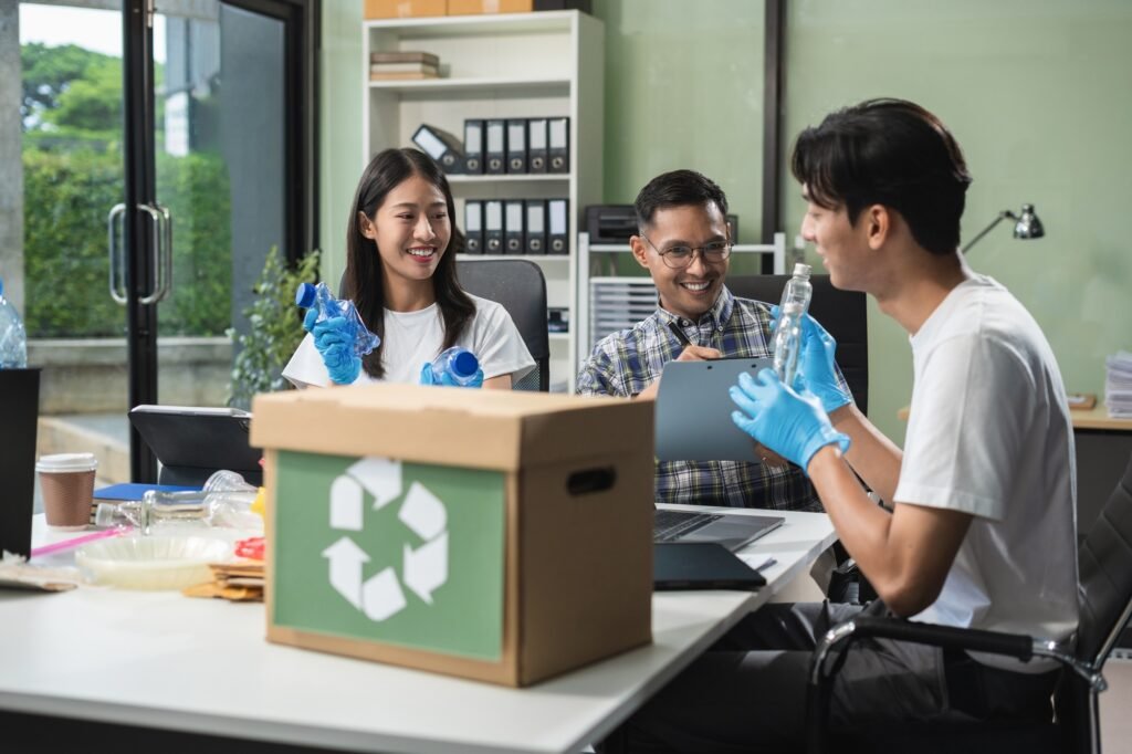 Business people working examining waste recyclable separation divided bin in the office,