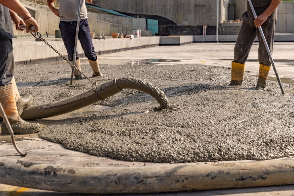 Construction worker pouring a wet concret