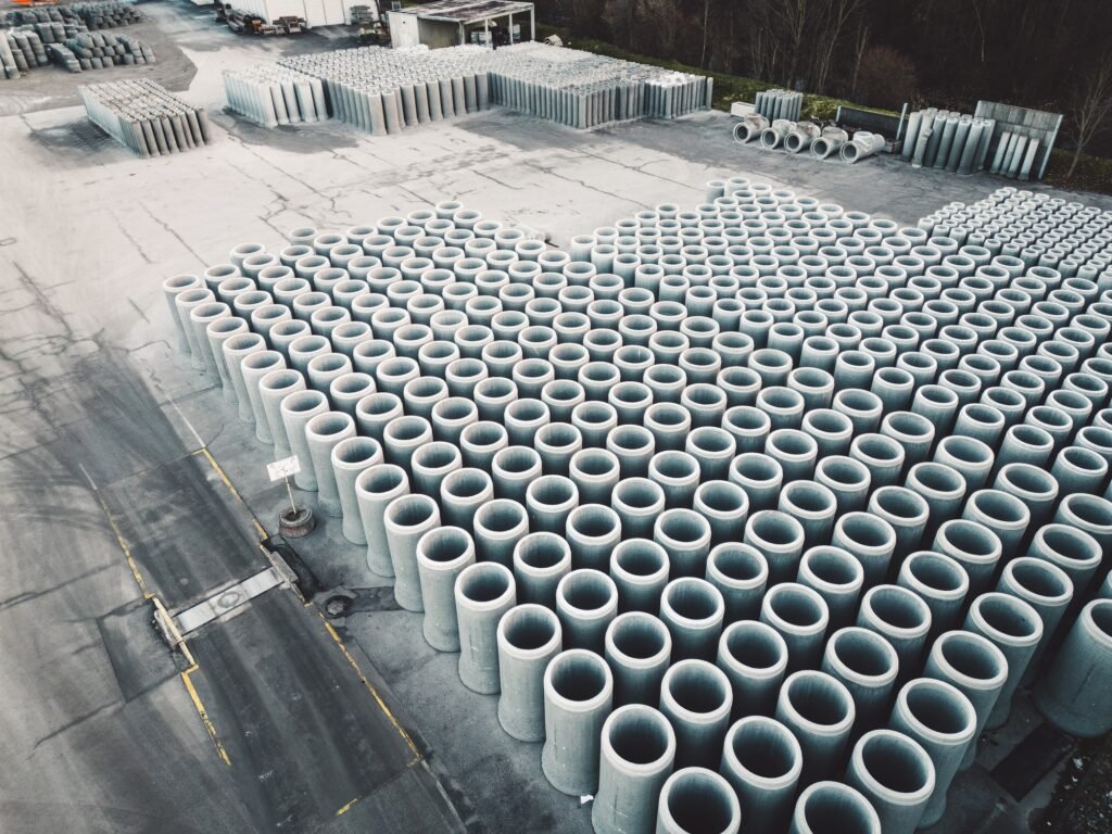 Huge concrete pipes stacked in lines, aerial view