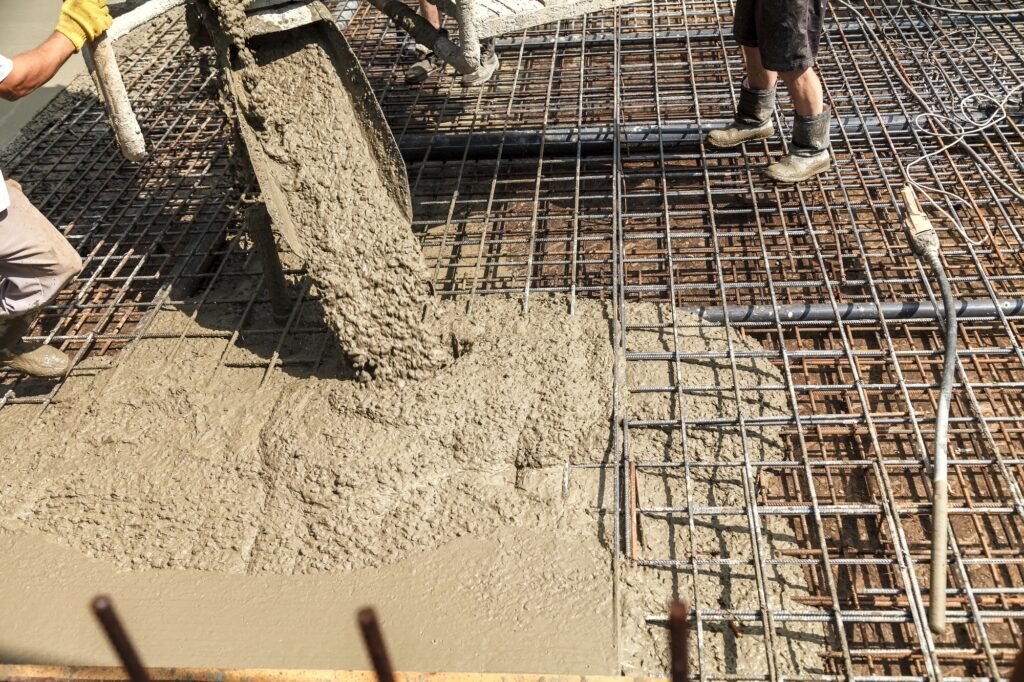 Pouring concrete into the construction of the house. Builders are pouring ready-mixed concrete