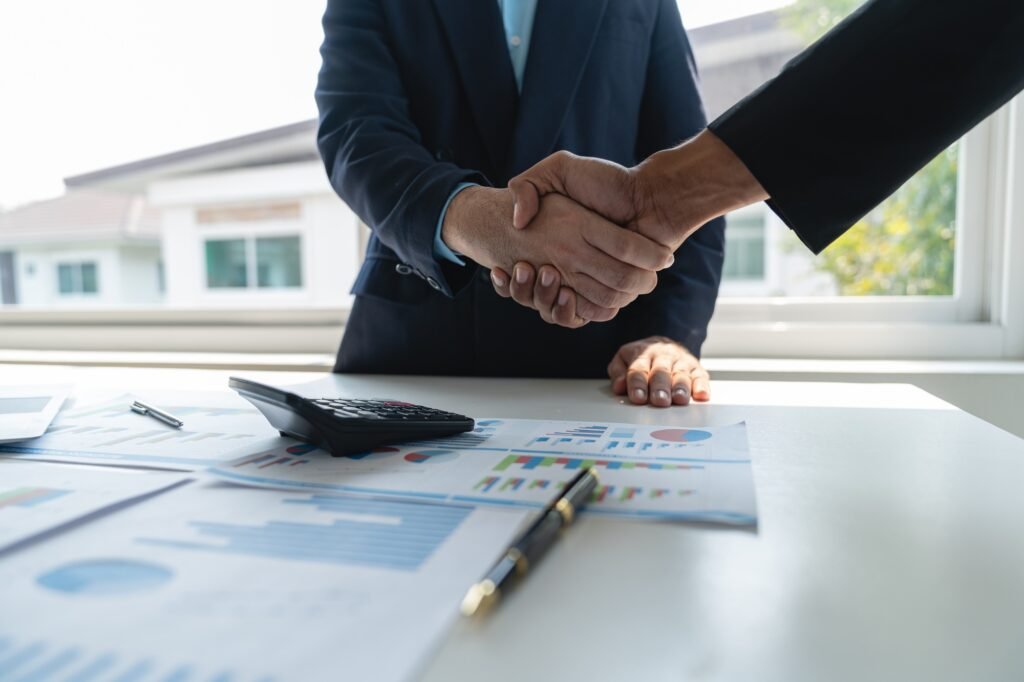 Support, young asian businessman shaking hands with partner after completion and successful financia