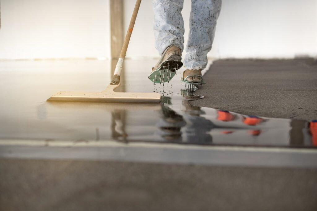 Worker working on the floor of an industrial building with special shoes to avoid