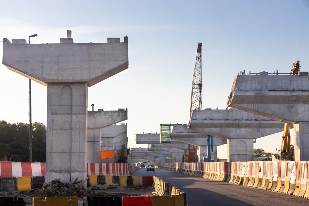 Construction of highway overpass bridge infrastructure in progress with morning sun rays